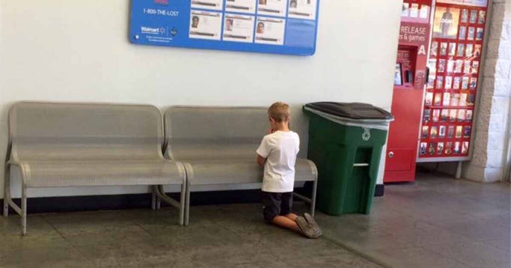 Photo Of Young Boy Praying In Front Of Poster At Walmart Catches The Attention Of Internet Users