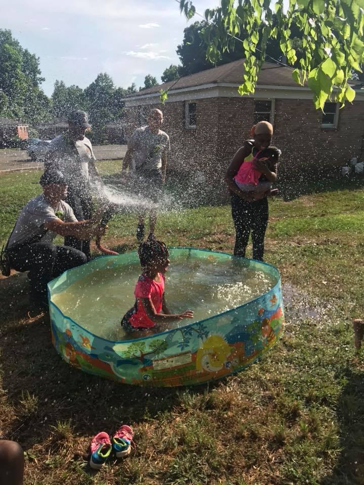 Firefighters come to a halt after they spot a struggling mom filling kids’ pool using a pot
