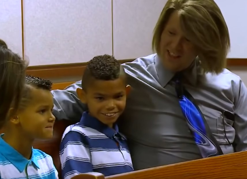 Young siblings living in different foster homes react to the news that they will be adopted together