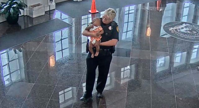 Kind police officer steps up to hold baby so that struggling mom can land a job