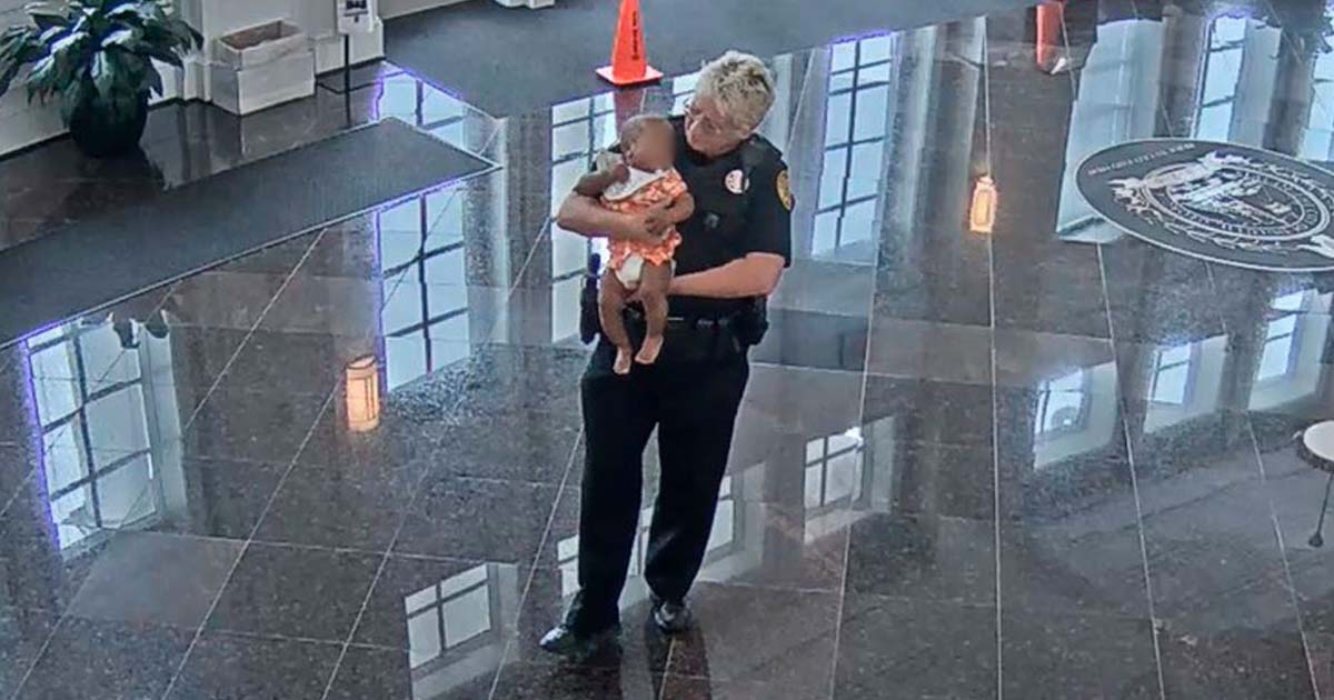 Kind police officer steps up to hold baby so that struggling mom can land a job