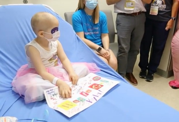 Doctor dresses in pink unicorn outfit and holds "no more chemo" party for four-year-old cancer survivor