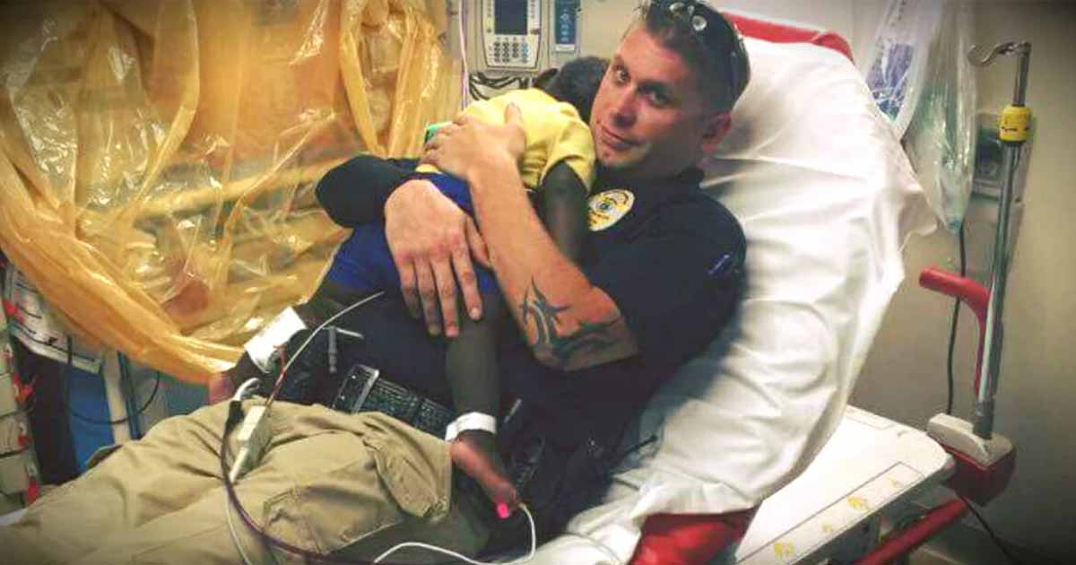 Police officer snuggles abandoned toddler in hospital bed after finding him wandering the streets alone