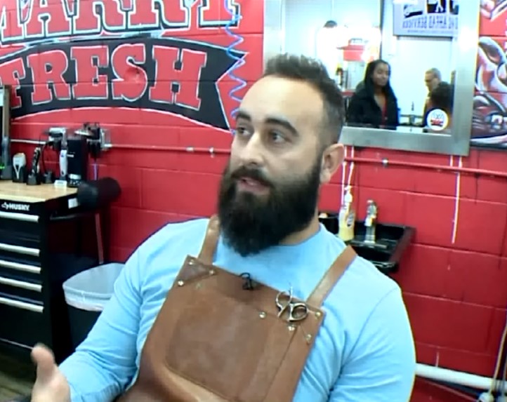 Kind barber takes chair outside so overwhelmed autistic boy can get his new haircut