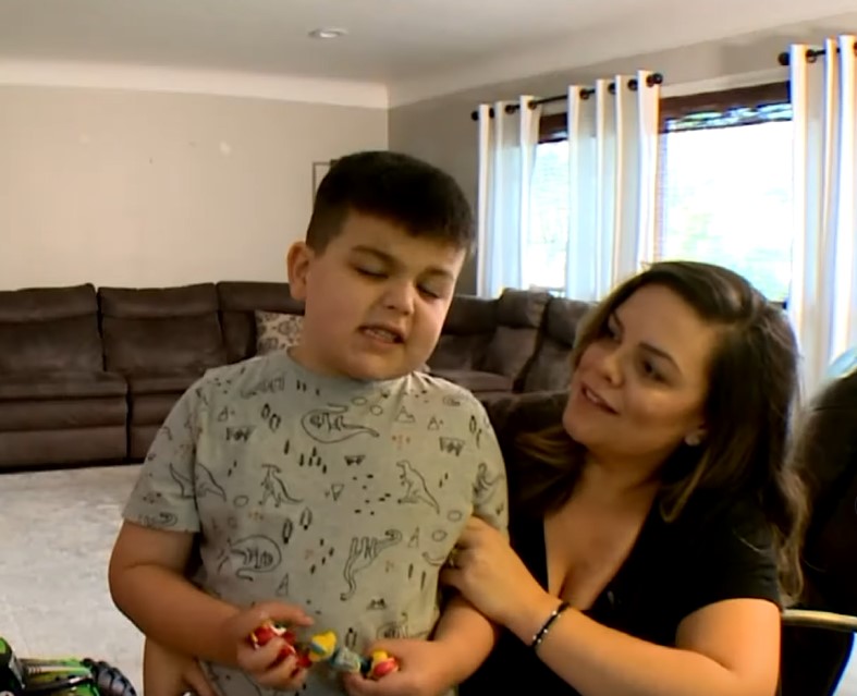 Kind barber takes chair outside so overwhelmed autistic boy can get his new haircut