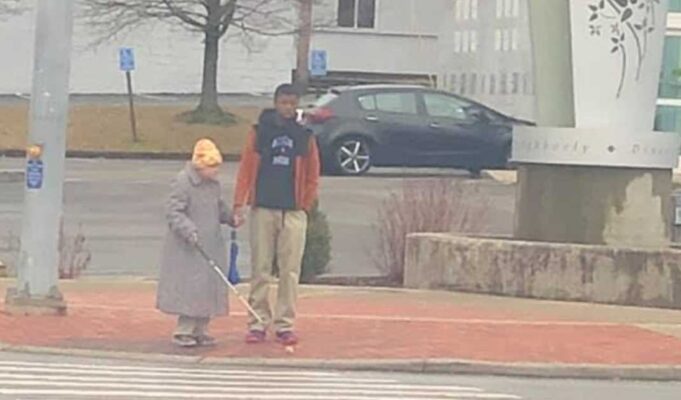 Photo of teen helping an elderly blind woman cross the busy street goes viral— He deserves our recognition