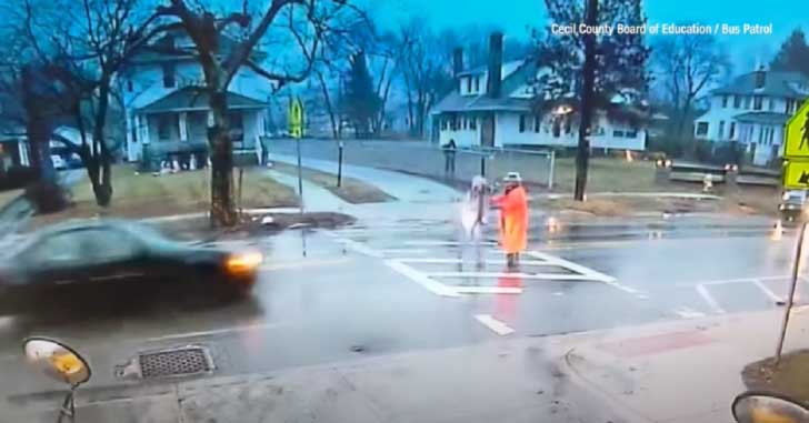 Brave crossing guard risked being struck by a speeding car in order to save a child