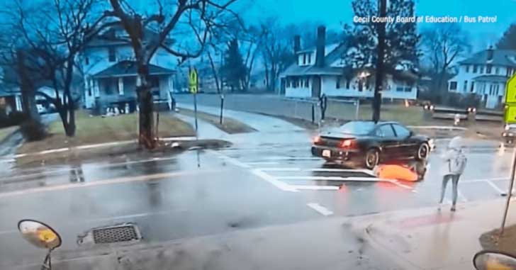 Brave crossing guard risked being struck by a speeding car in order to save a child
